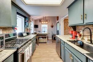 a kitchen with blue cabinets and a counter top at Little Woodland Home Hidden Gem By Dtwn Bethlehem in Bethlehem