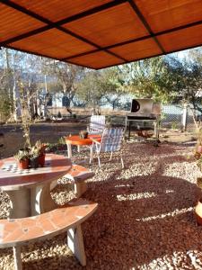 a patio with a table and chairs and a piano at Nature and Comfort - Cabaña Cuatro Vientos in Carpintería