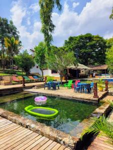 a pool with a green raft in the water at Finca privada de lujo Casalegre in Pance