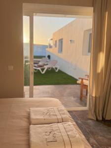a bedroom with a bed and a view of a patio at The Suite Villa in Playa Blanca