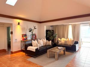 a living room with a couch and a table at The Suite Villa in Playa Blanca