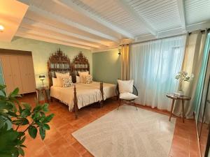 a bedroom with a bed and a chair at The Suite Villa in Playa Blanca +35 photos