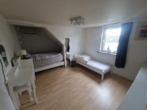 a small bedroom with a bed and a window at Ferienhaus an der Nieste in Niestetal