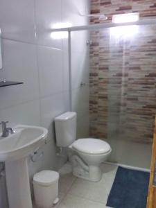 a bathroom with a toilet and a sink at Condomínio Bezerra in Maragogi +6 photos