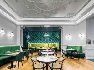 a restaurant with tables and chairs and a ceiling at Century Old Town Prague - MGallery Collection in Prague +174 photos