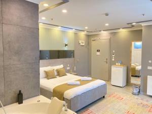 a bedroom with a large bed and a bath tub at Sahrakent Otel Pendik in Istanbul +182 photos