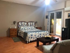 a bedroom with a bed and a couch at Hotel Durazno in Durazno