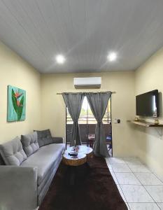 a living room with a couch and a table at Departamento Amoblado en pleno Centro Hohenau in Hohenau