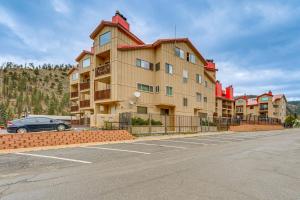 a building with a car parked in a parking lot at Easy Red River Ski Access! Outdoor Adventure Condo in Red River