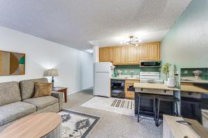 a living room with a couch and a kitchen at Easy Red River Ski Access! Outdoor Adventure Condo in Red River