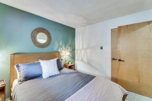 a bedroom with a bed and a mirror on the wall at Easy Red River Ski Access! Outdoor Adventure Condo in Red River