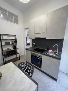 a kitchen with a sink and a stove at Galaxy Colosseum Apartment - a 450m dal Colosseo in Rome
