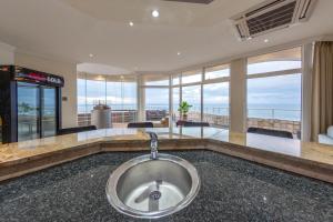 a bathroom with a sink with a view of the ocean at Unit 1101 Oyster Rock in Durban
