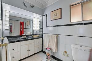 a bathroom with a sink and a toilet and a mirror at The Jordan View in Titus +55 photos