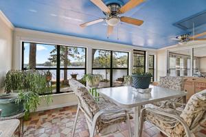 a dining room with a table and chairs and windows at The Jordan View in Titus