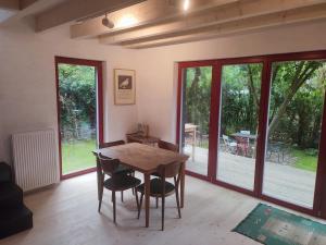 a dining room with a wooden table and chairs at Romantický domek Slapy in Brunšov