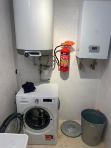 a kitchen with a washing machine in a room at Romantický domek Slapy in Brunšov