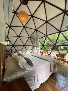 a bedroom with a large bed in a tent at Domo na praia - Arraial D'Ajuda in Arraial d'Ajuda