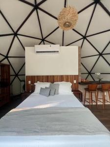 a bedroom with a large bed in a tent at Domo na praia - Arraial D'Ajuda in Arraial d'Ajuda