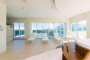a large room with white chairs and a table at Saint Moritz Hotel em Brasília 63873 in Brasilia +39 photos