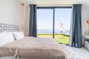 a bedroom with a bed and a large window at Villara Bodrum in Bodrum City +44 photos