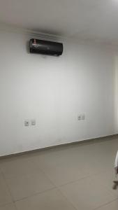 a black object on a white wall in a room at Quarto Porto in Porto Seguro
