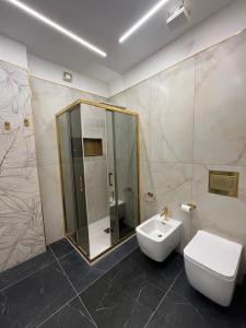 a bathroom with a sink and a toilet and a shower at Omero in Reggio di Calabria +8 photos