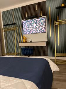 a bedroom with a flat screen tv on a wall at Omero in Reggio di Calabria