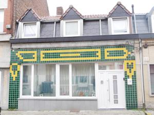 a building with a tiled front of it at VancyLove Home in Mons