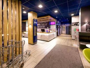 a store lobby with a counter and a shopping cart at Ibis budget Berlin Potsdamer Platz in Berlin