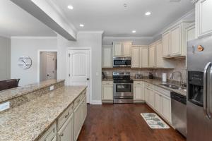 a kitchen with white cabinets and granite counter tops at 306 Reserve Lane in Jewtown