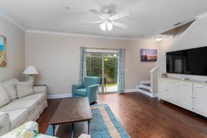 a living room with a couch and a flat screen tv at 306 Reserve Lane in Jewtown