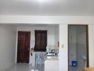 a room with a kitchen with a counter and a door at RB Baruiz "Hideaway" Inn - Cebu South in Cebu City +28 photos