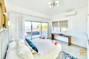 a bedroom with a bed and a large window at Beachfront Compound, Pool, BBQ, Best for Groups in Refugio +24 photos