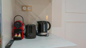 a counter top with a coffee maker and a tea kettle at Luxurious Apartment Stylish Design - René Boulanger in Paris