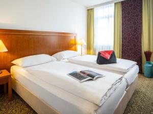 Postel nebo postele na pokoji v ubytování Hotel Mercure Wien Westbahnhof