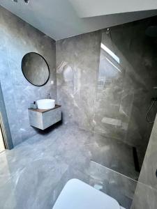 a bathroom with a sink and a mirror at La Izvor Moinești, Cazare in Moineşti