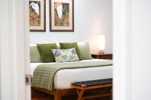 a bedroom with a bed with a table and pictures on the wall at 617 Neptune Way in Demere Park