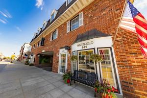 a red brick building with an american flag on it at The Westfield Inn, BW Signature Collection in Westfield