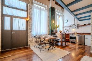 a kitchen and dining room with a table and chairs at LOFT near Bocconi and the Center in Milan +15 photos