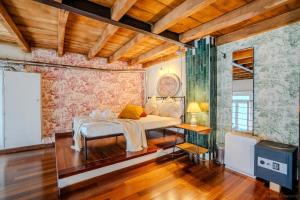 a bedroom with a bed in a room with wooden ceilings at LOFT near Bocconi and the Center in Milan