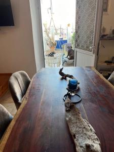 a wooden table with a branch on top of it at Traditionelles Dorfhaus Malona in Malona Village