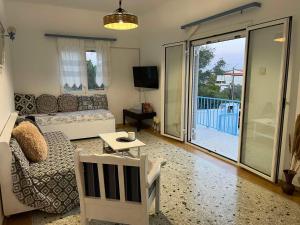 a living room with a couch and a table at Eva's house in Rafina