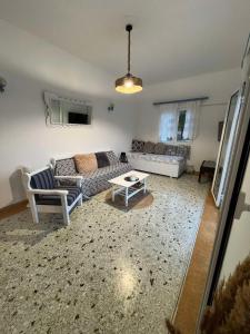 a living room with a couch and a table at Eva's house in Rafina