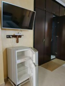 a living room with a tv and a white cabinet at blue door imsouane in Imsouane