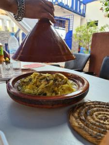 a bowl of food sitting on top of a table at blue door imsouane in Imsouane