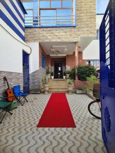 a red carpet on the floor of a house at blue door imsouane in Imsouane