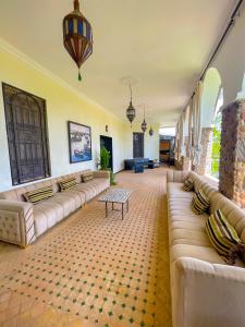 a large living room with couches and a table at Nassau FarmHouse in Mellah Bakka