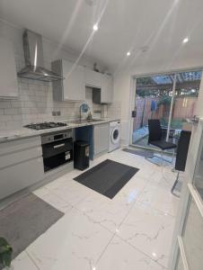 a kitchen with a sink and a stove top oven at 3SIEE Homes in Luton
