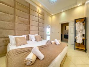 a bedroom with a large bed with towels on it at Nassau FarmHouse in Mellah Bakka +71 photos